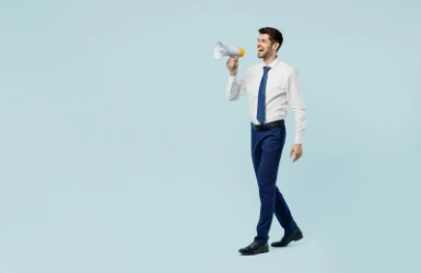 Mann mit Hemd und Krawatte ruft ins Megafon